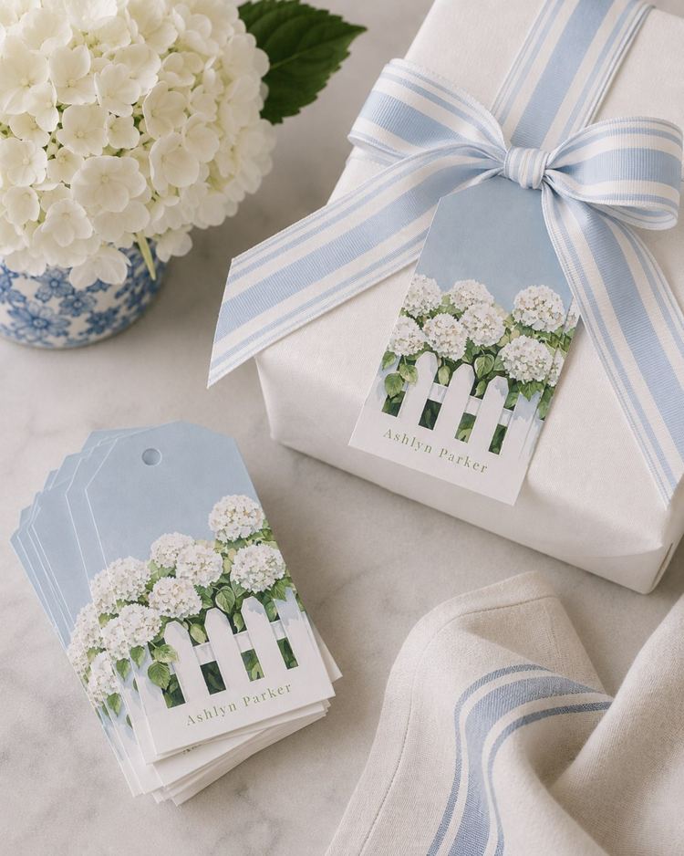 Hydrangea enclosure cards beside a wrapped gift