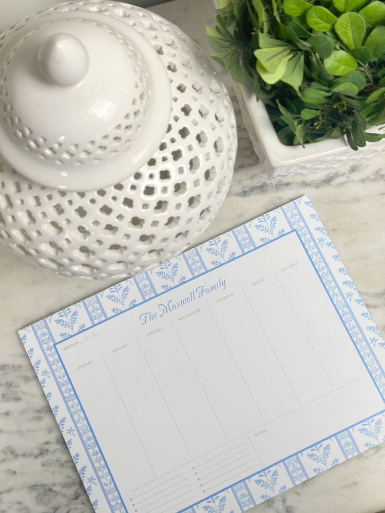 Blue patterned weekly planner on marble