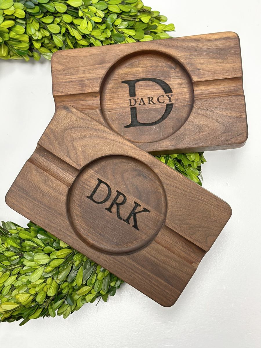 Personalized wooden cigar ash trays on greenery